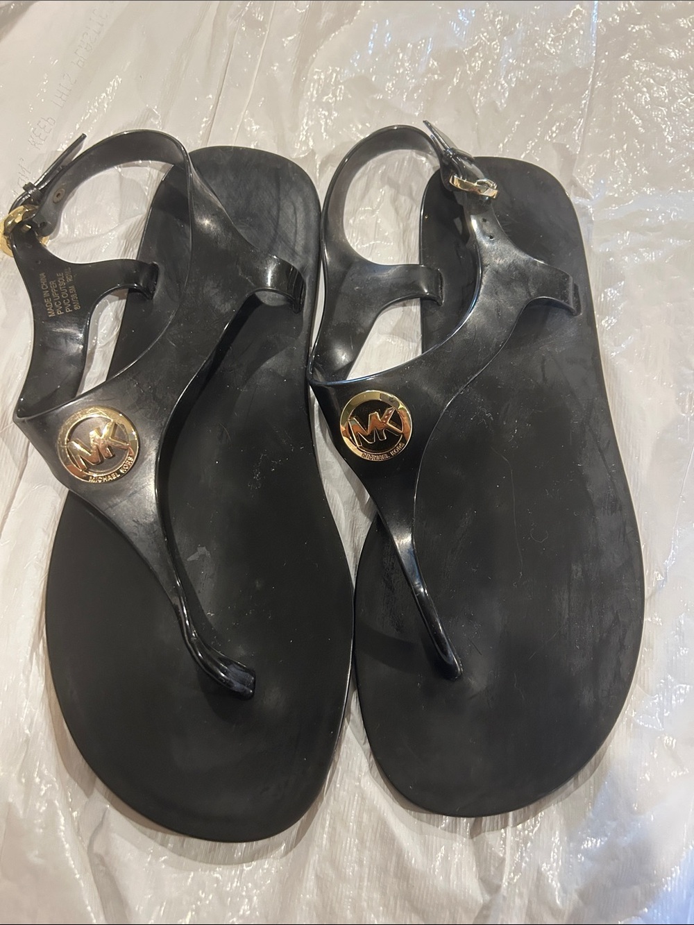 Michael Kors Black Jelly Logo Thong Sandals with Gold MK Medallion